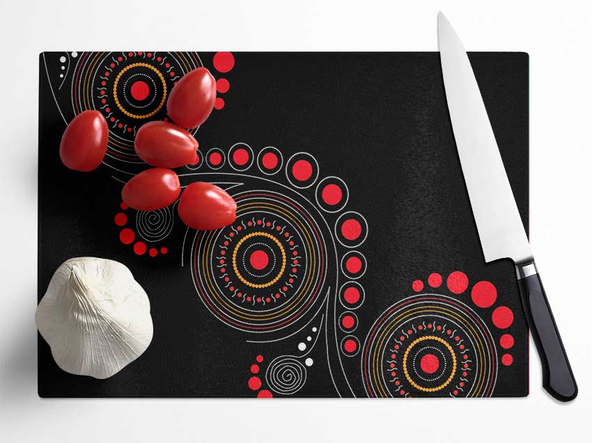 Aboriginal Pattern 12 chopping board made of tempered glass with a chinchilla ripple effect and anti-slip feet.