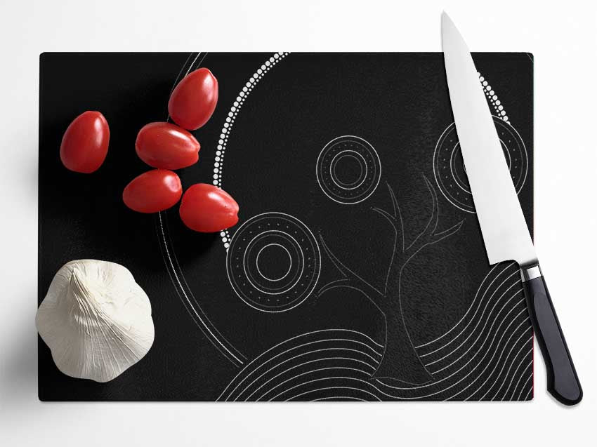 Aboriginal Pattern 13 chopping board made of tempered glass with a chinchilla ripple effect and anti-slip feet.