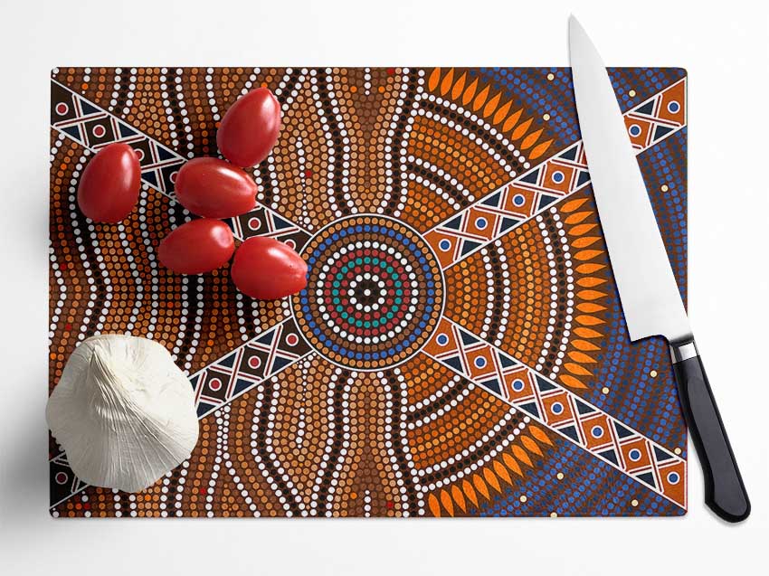 Aboriginal Pattern 2 chopping board made of tempered glass with chinchilla ripple effect and anti-slip feet.