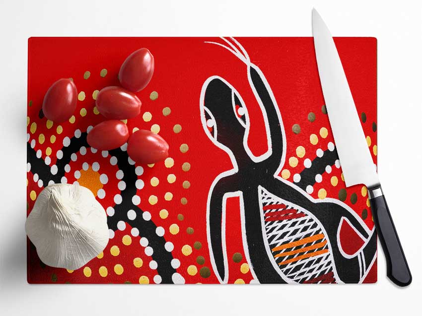 Aboriginal Red Gecko Sun chopping board made of tempered glass with a chinchilla ripple effect and anti-slip feet.