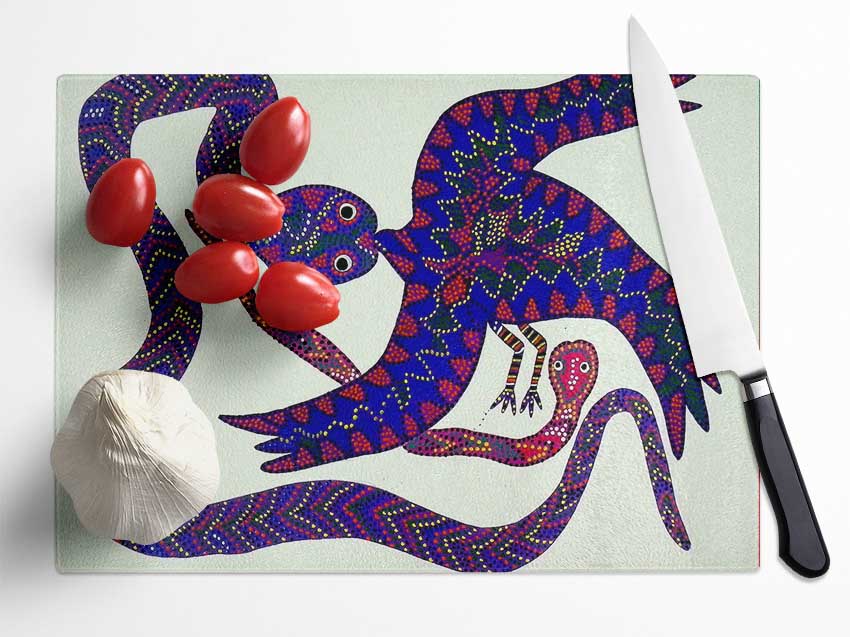 Aboriginal Snake Bird chopping board made from tempered glass with chinchilla ripple effect and anti-slip feet.