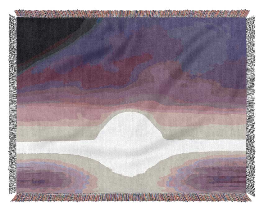 A luxurious Abstract Sun Lilac throw blanket made from 100% cotton, featuring a beautiful thermal weave, draped elegantly over a couch.