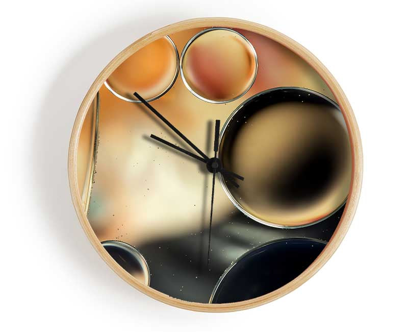 Abstract Circles Droplets clock made of natural bamboo with a round face and clear Plexiglas lens, available in black, white, and natural frame colors.