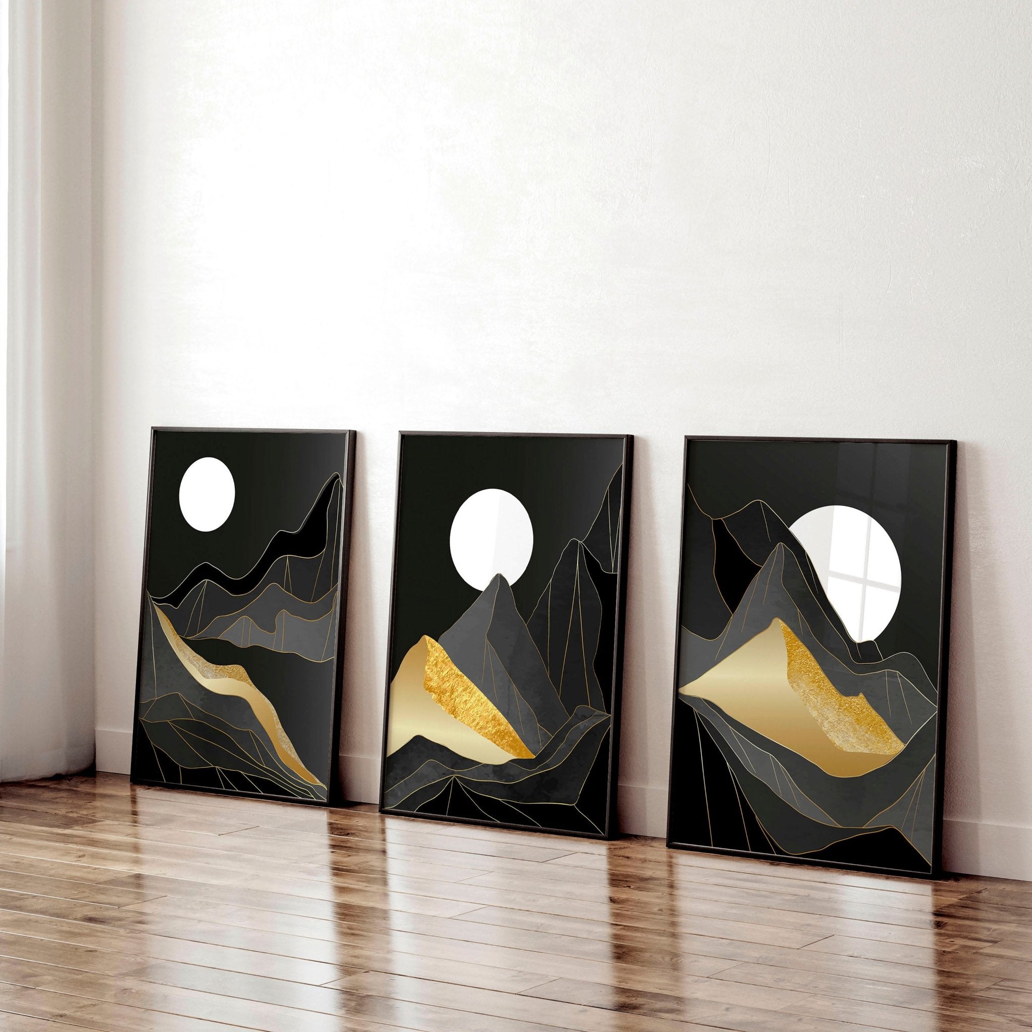 Set of 3 abstract landscape wall art prints featuring black, grey, and gold hues, perfect for modern home decor.