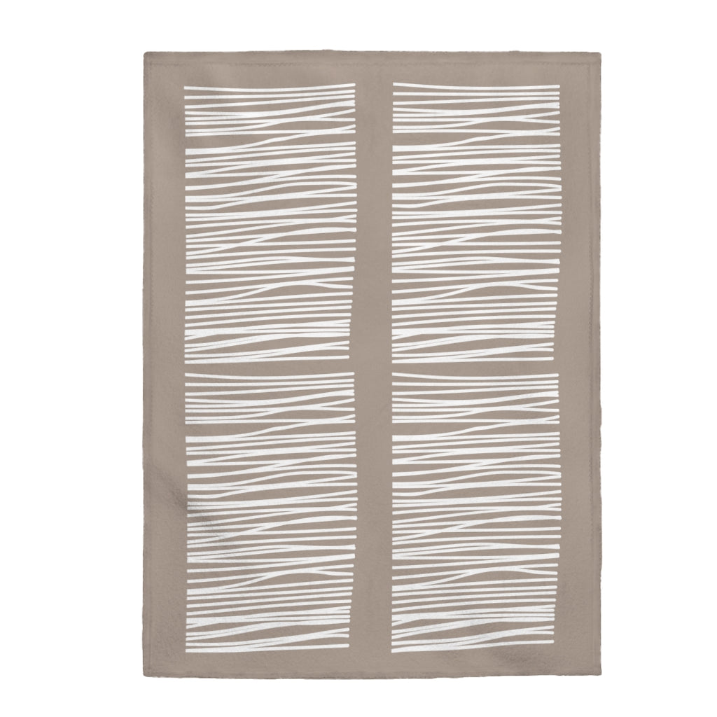 A cozy Abstract Lines in Beige plush blanket throw draped elegantly over a couch, showcasing its soft velveteen texture and stylish abstract design.