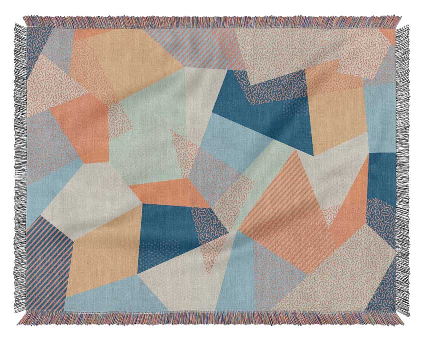 A luxurious Abstract Triangles throw blanket made from 100% cotton, featuring a stylish geometric design in soft colors, perfect for home decor.