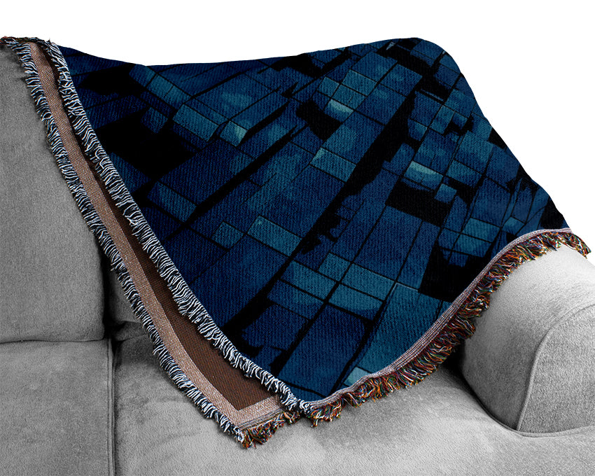 A luxurious Abstract Tunnel throw blanket made from 100% cotton, featuring a thermal weave design, draped elegantly over a couch.