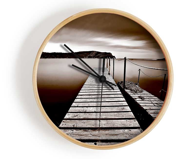 AbstractBrown Pier clock made from natural bamboo with a round face and clear Plexiglas lens, available in black, white, and natural frame colors.