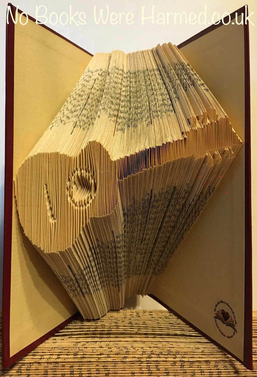 Handcrafted Acoustic Guitar art made from vintage book pages, showcasing intricate folds and unique design.