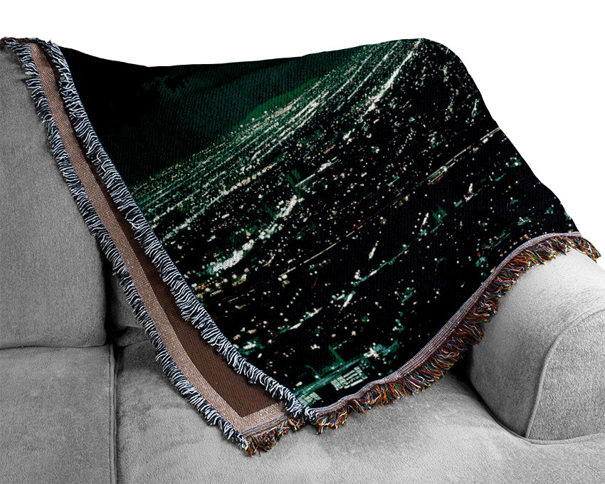 Aerial City View throw blanket made from 100% cotton, featuring a thermal weave for breathability and a luxurious finish, draped elegantly on a couch.