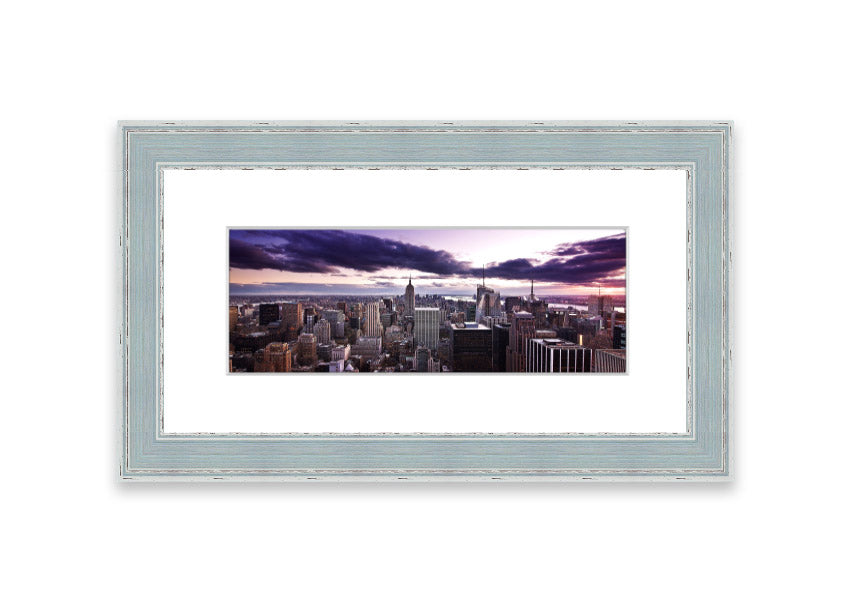 Framed print of New York City skyline at dusk, showcasing vibrant colors and intricate details.