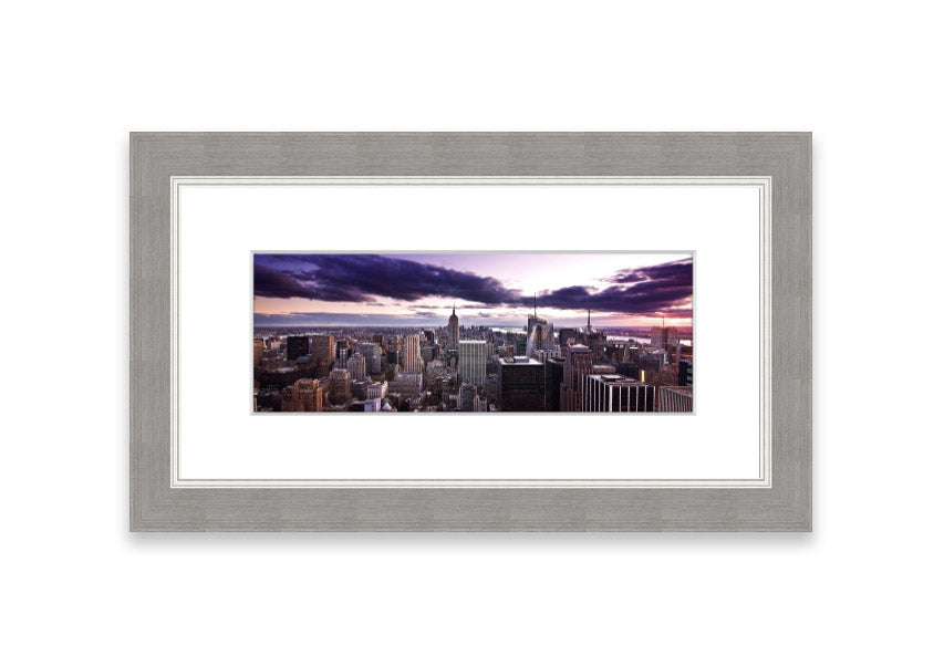 Framed print of New York City skyline at dusk, showcasing vibrant colors and intricate details.