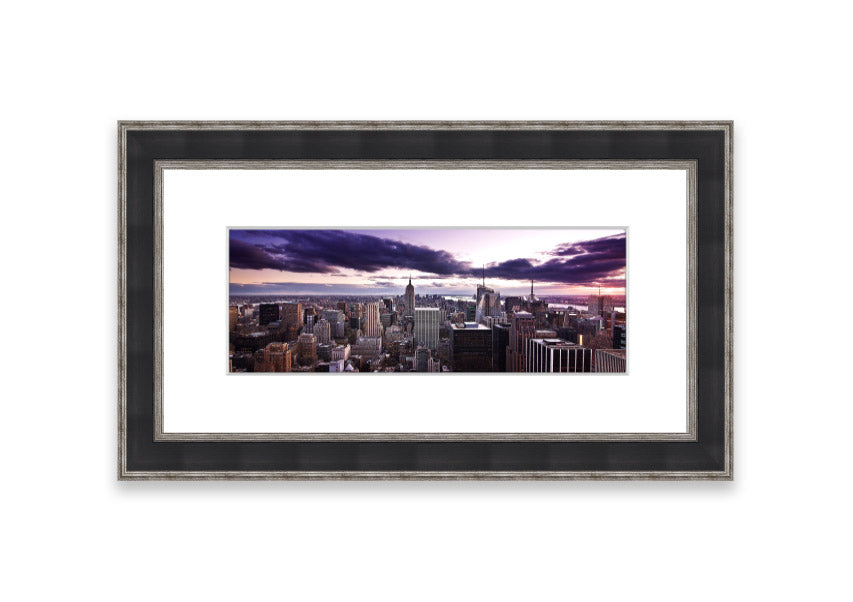 Framed print of New York City skyline at dusk, showcasing vibrant colors and intricate details.