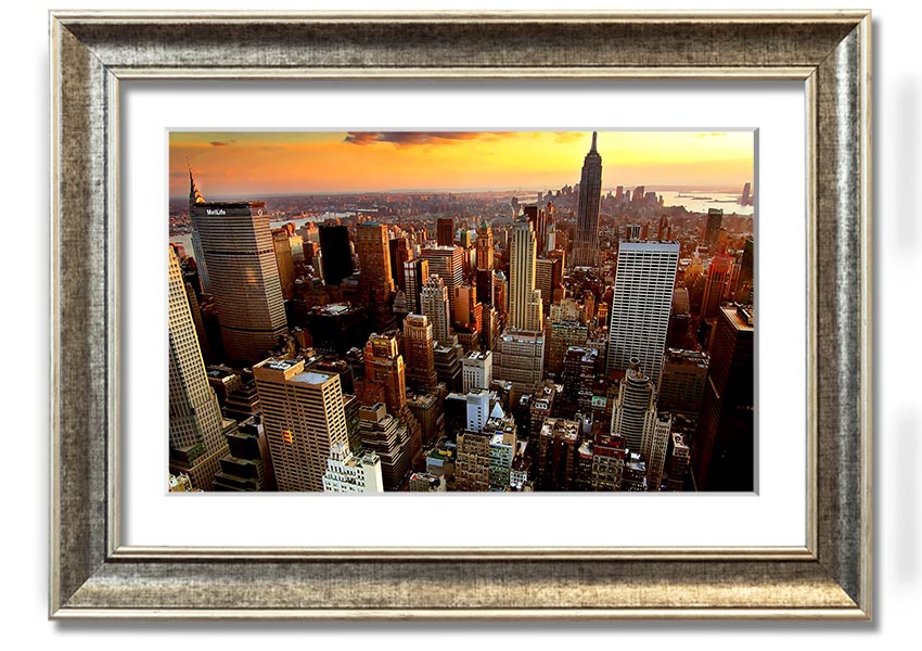 Aerial view of New York City at sunset, showcasing vibrant colors and iconic skyline, framed and ready to hang.