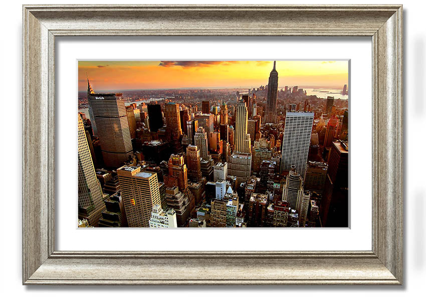 Aerial view of New York City at sunset, showcasing vibrant colors and iconic skyline, framed and ready to hang.