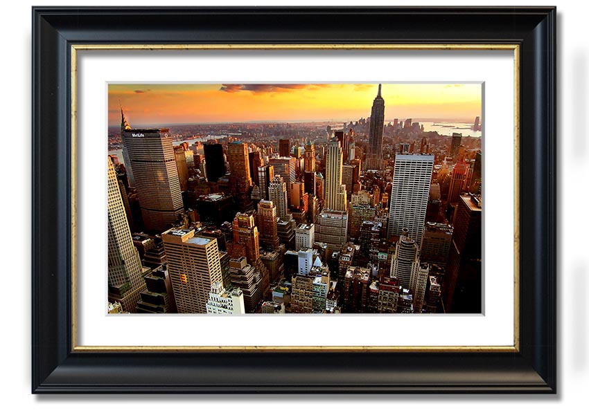 Aerial view of New York City at sunset, showcasing vibrant colors and iconic skyline, framed and ready to hang.