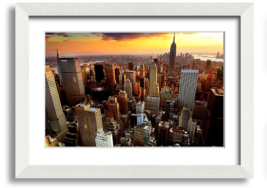 Aerial view of New York City at sunset, showcasing vibrant colors and iconic skyline, framed and ready to hang.