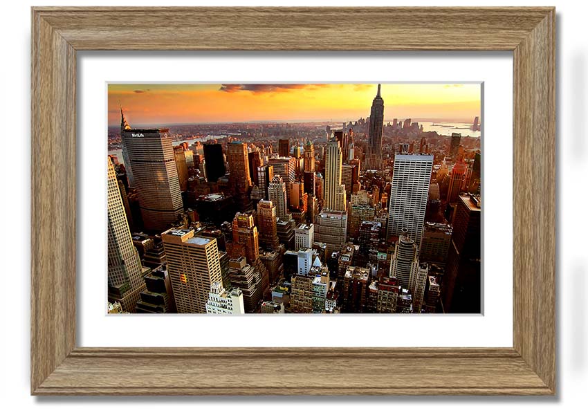 Aerial view of New York City at sunset, showcasing vibrant colors and iconic skyline, framed and ready to hang.