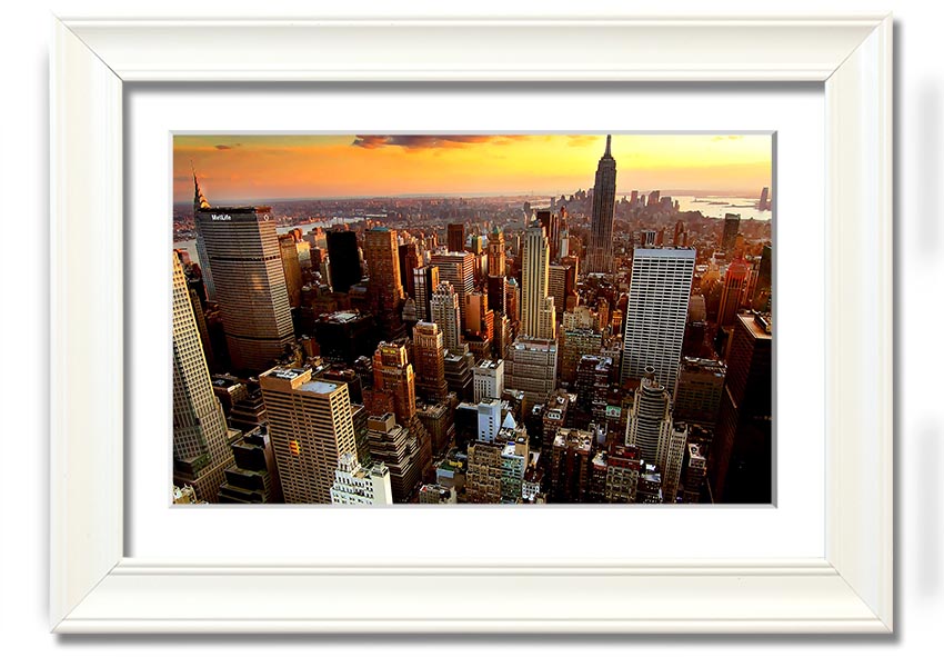 Aerial view of New York City at sunset, showcasing vibrant colors and iconic skyline, framed and ready to hang.