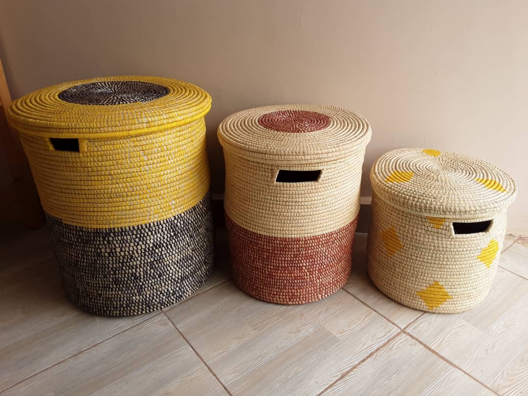 A beautifully woven African Raffia Laundry and Storage Basket with a lid, showcasing its natural texture and elegant design.