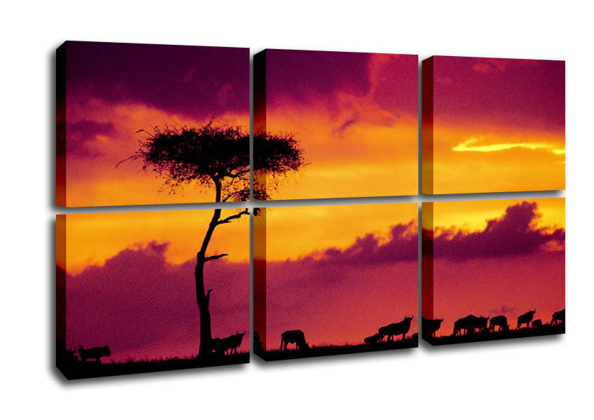 A vibrant canvas print depicting an African sunset, showcasing warm hues of orange, red, and purple over a silhouette of savannah trees.