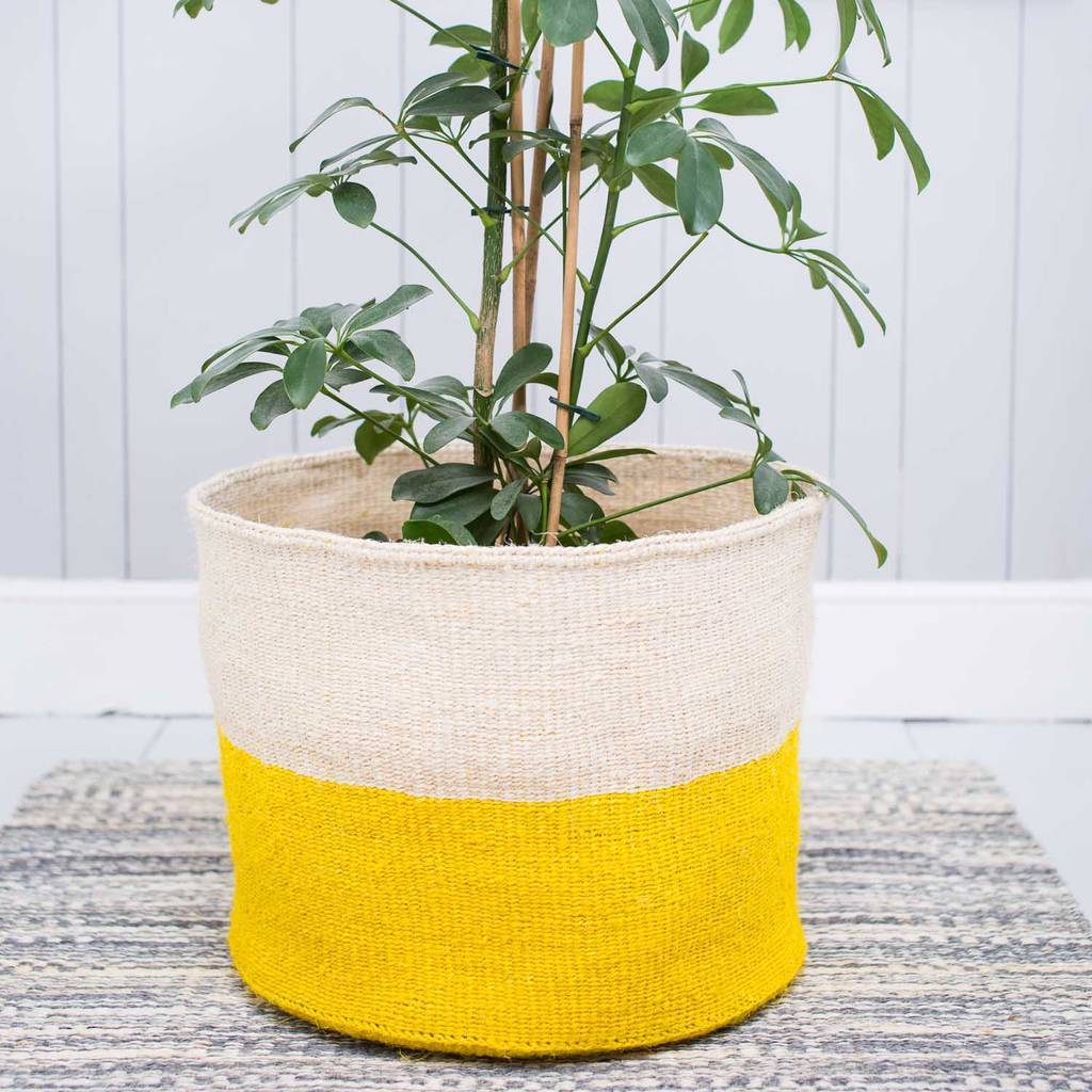 A beautifully handcrafted African Sisal Storage Basket, showcasing intricate weaving patterns and vibrant colors, perfect for home organization.