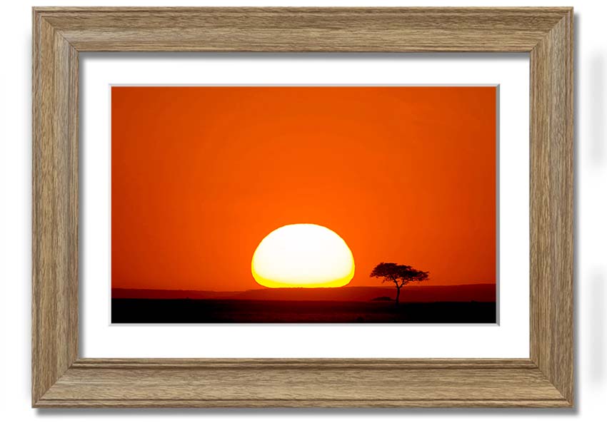 A beautifully framed print of an African sunrise, showcasing vibrant colors and landscape details, ready to hang.