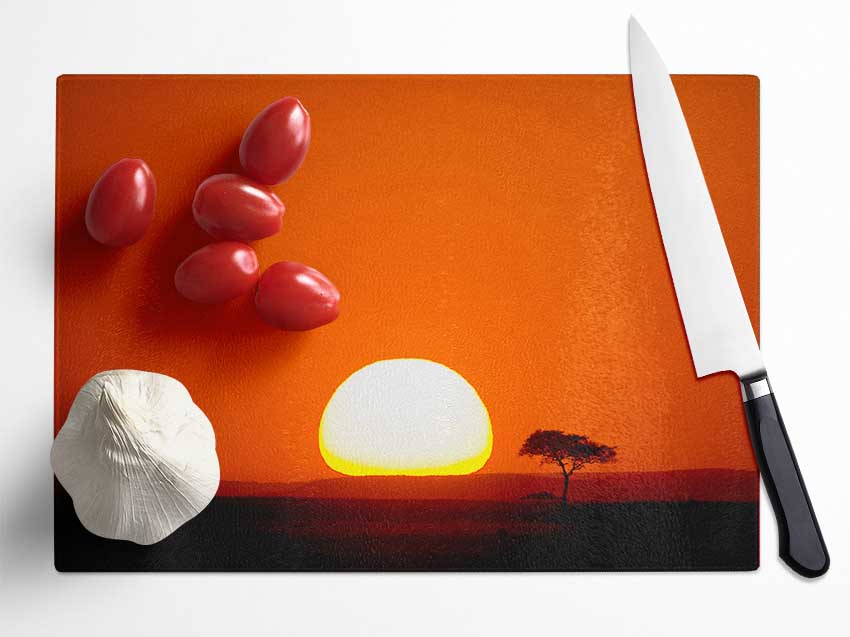 A beautifully designed African Sunrise chopping board made of tempered glass, featuring a chinchilla ripple effect and anti-slip feet.