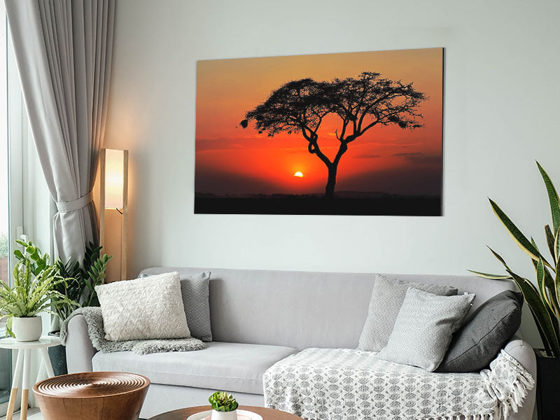 A vibrant artwork depicting an African sunset printed on brushed aluminium dibond, showcasing warm colors and intricate details.