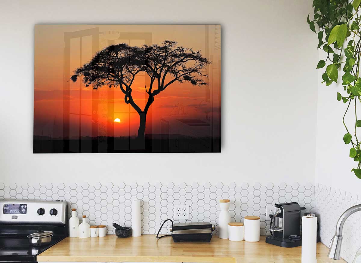 A vibrant glass print depicting an African sunset with rich colors of orange, red, and purple, perfect for modern home decor.