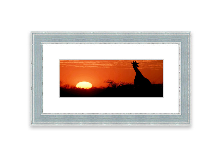 Framed print of an African sunset with a giraffe silhouette, showcasing vibrant colors and elegant design.