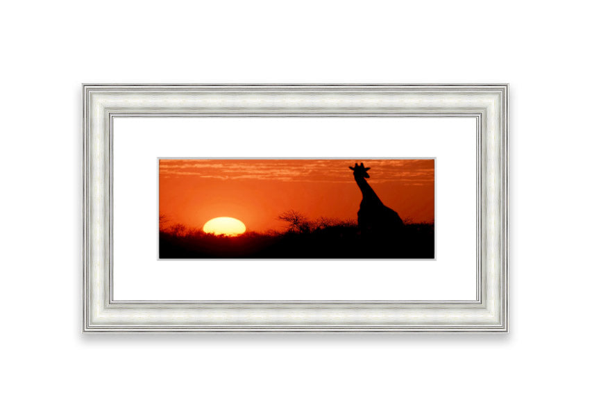 Framed print of an African sunset with a giraffe silhouette, showcasing vibrant colors and elegant design.