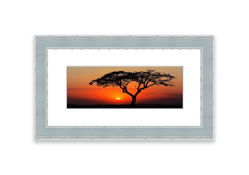 Framed print of an African sunset, showcasing vibrant colors and serene landscape, ready to hang.