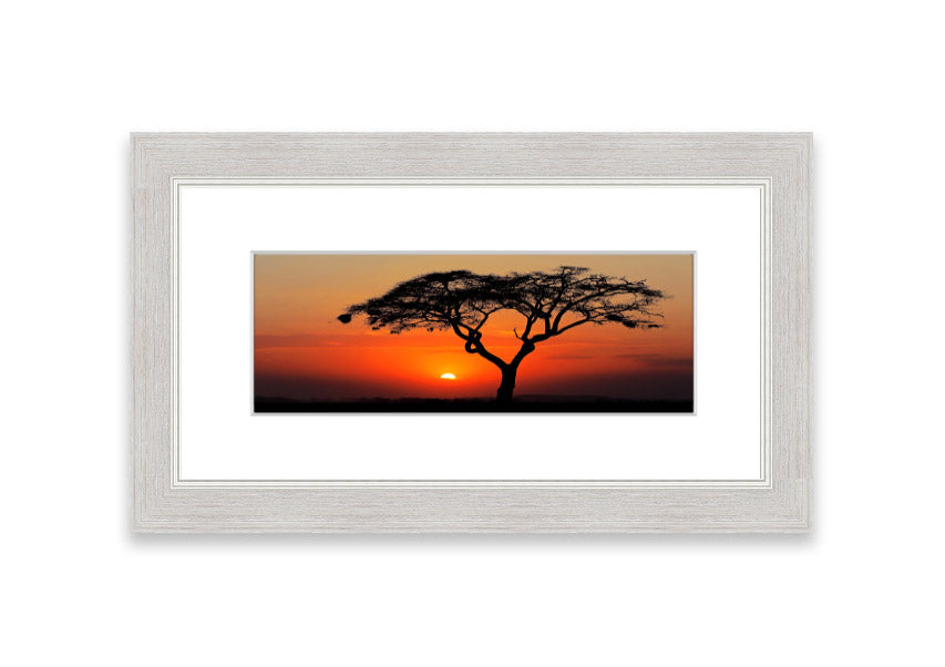 Framed print of an African sunset, showcasing vibrant colors and serene landscape, ready to hang.