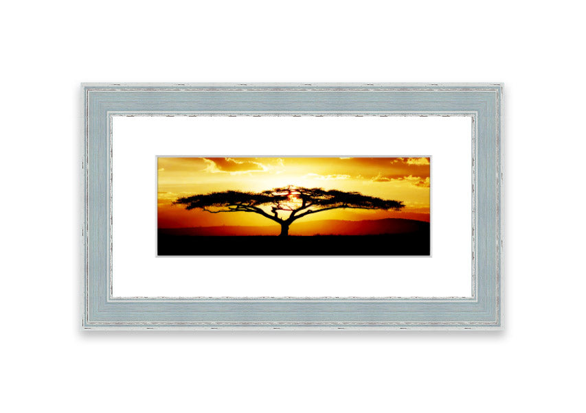 Framed print of an African tree at sunset, showcasing vibrant colors and a serene landscape.