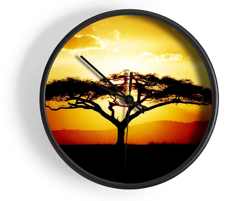 A stylish clock featuring an African tree silhouette against a vibrant sunset, crafted from natural bamboo.