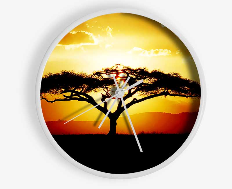 A stylish clock featuring an African tree silhouette against a vibrant sunset, crafted from natural bamboo.