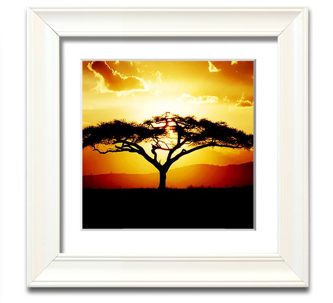 A beautifully framed print of an African tree at sunset, showcasing vibrant colors and intricate details.