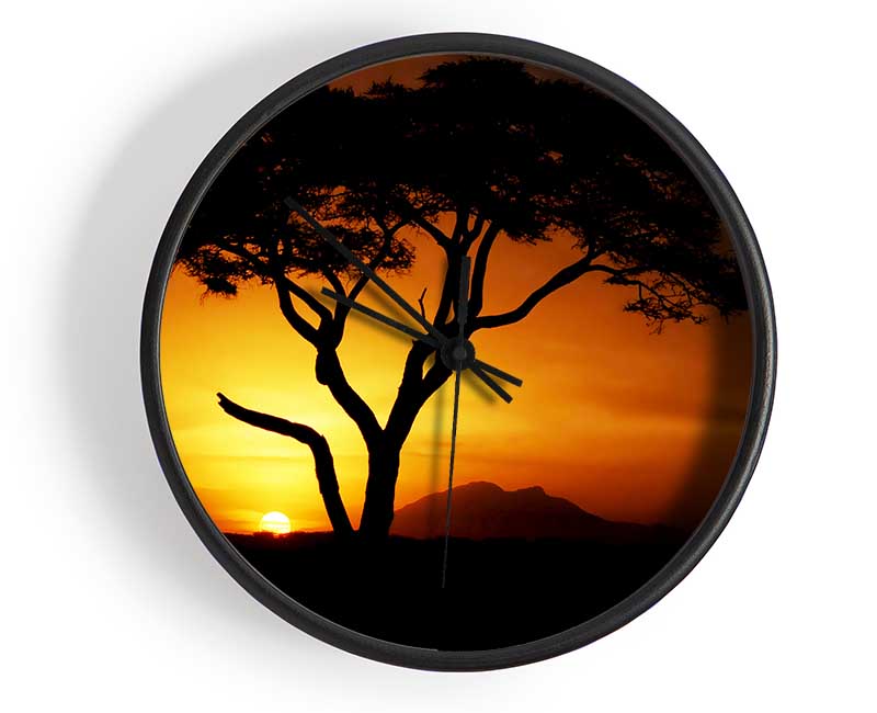 A beautifully designed clock featuring an African tree silhouette against a golden sunlight background, made from natural bamboo.