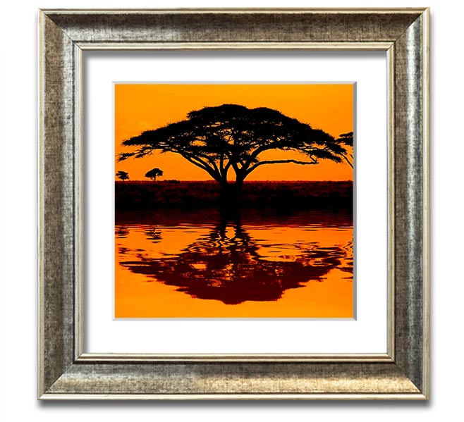 A beautifully framed print of an African tree reflecting in serene waters, showcasing vibrant colors and intricate details.