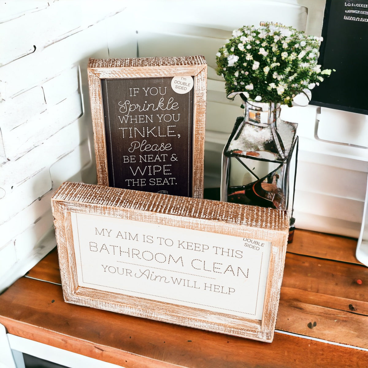 Aim + Sprinkle Tinkle double-sided bathroom sign with wooden frame, featuring humorous cleanliness messages.