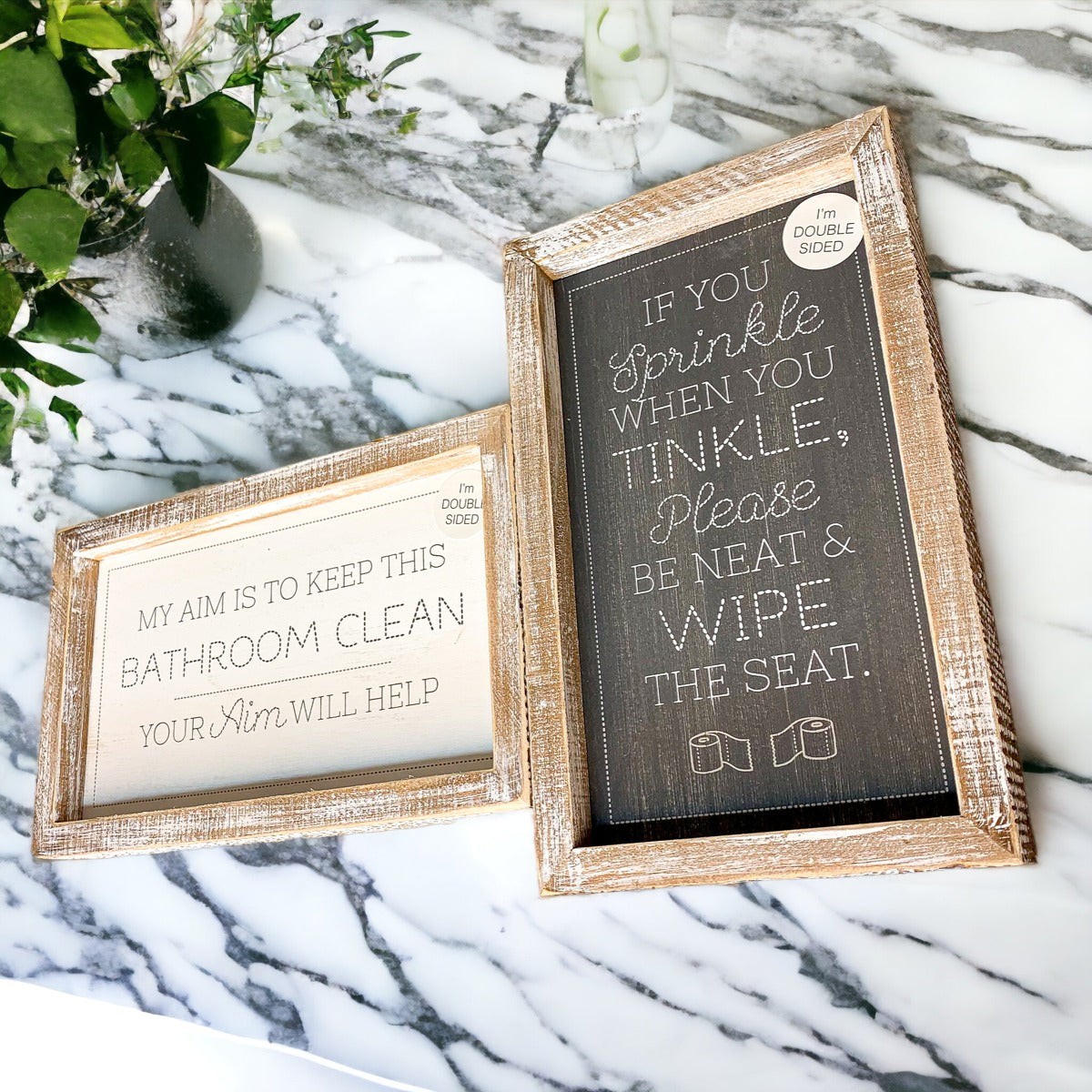 Aim + Sprinkle Tinkle double-sided bathroom sign with wooden frame, featuring humorous cleanliness messages.