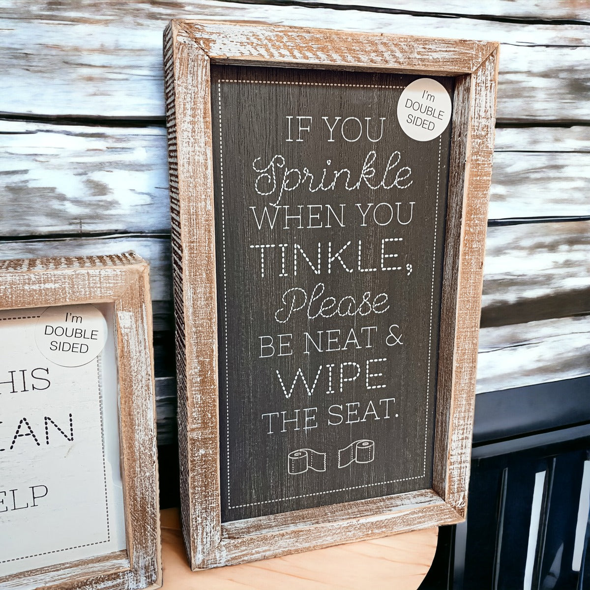 Aim + Sprinkle Tinkle double-sided bathroom sign with wooden frame, featuring humorous cleanliness messages.