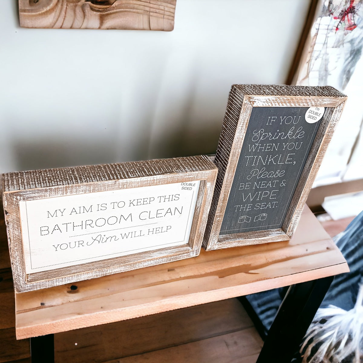 Aim + Sprinkle Tinkle double-sided bathroom sign with wooden frame, featuring humorous cleanliness messages.