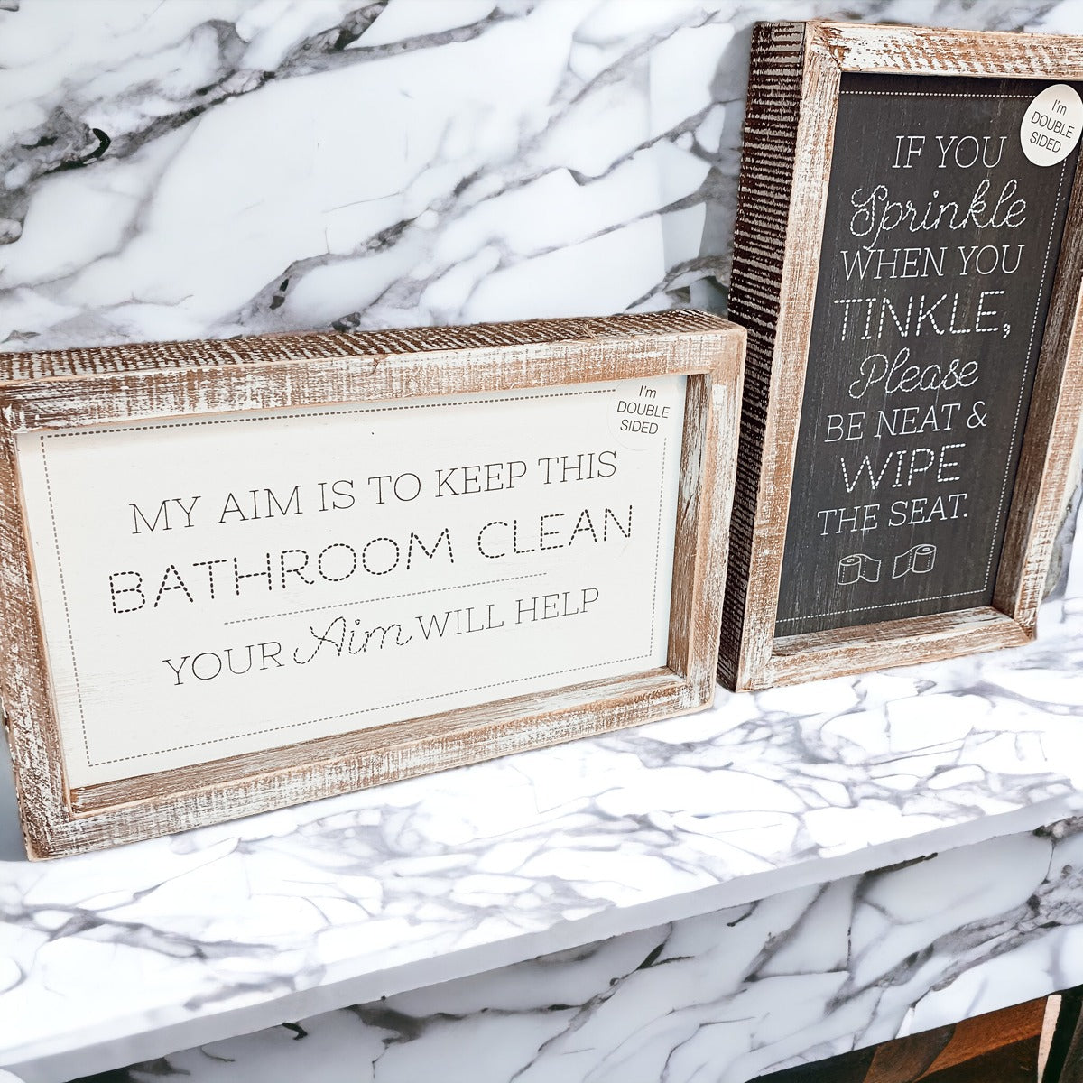 Aim + Sprinkle Tinkle double-sided bathroom sign with wooden frame, featuring humorous cleanliness messages.