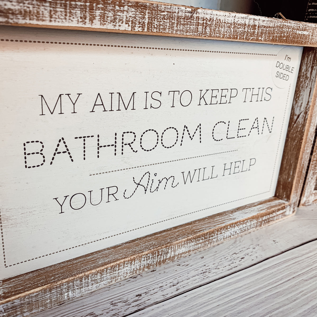 Aim + Sprinkle Tinkle double-sided bathroom sign with wooden frame, featuring humorous cleanliness messages.