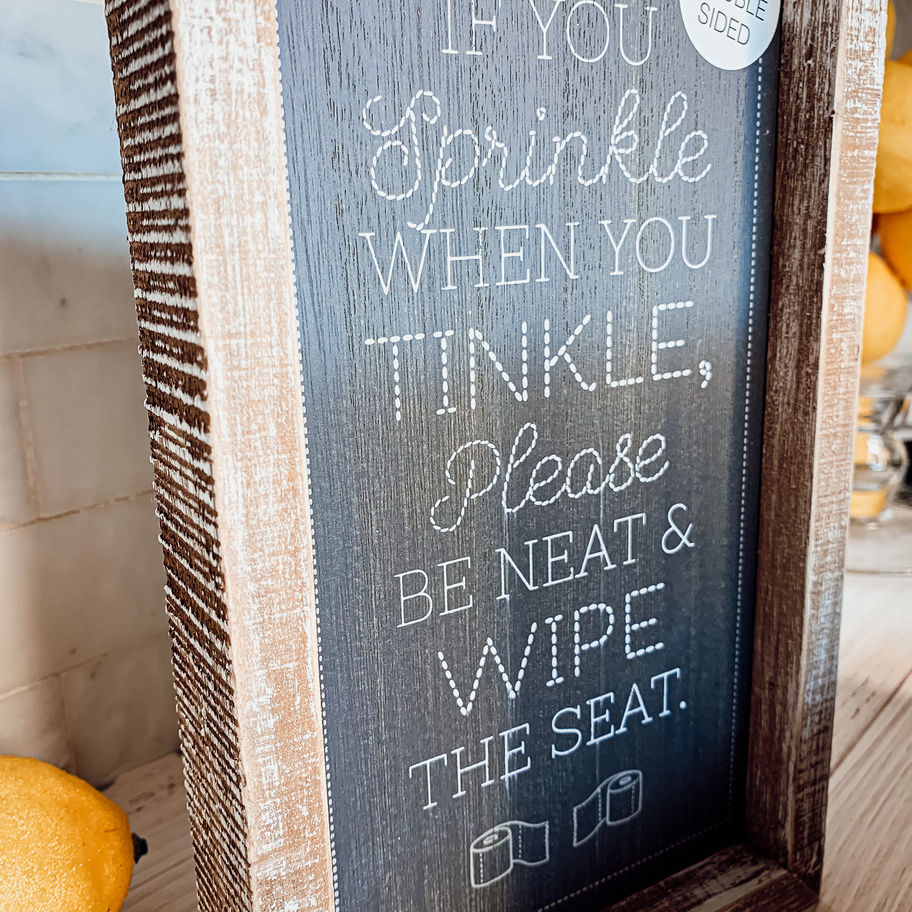 Aim + Sprinkle Tinkle double-sided bathroom sign with wooden frame, featuring humorous cleanliness messages.