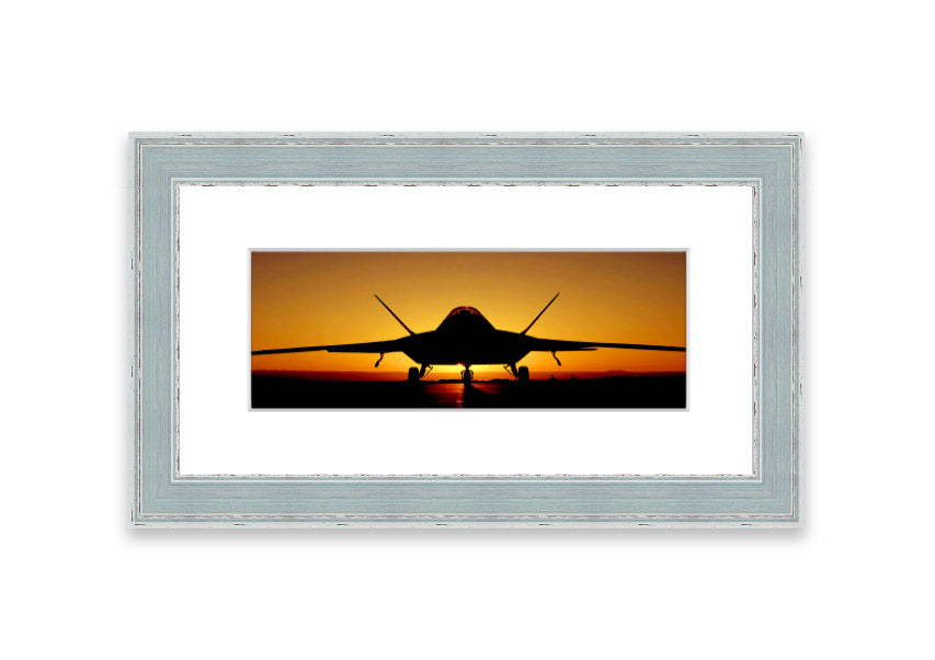 Framed print of an airplane at sunset, showcasing vibrant colors and a serene landscape.