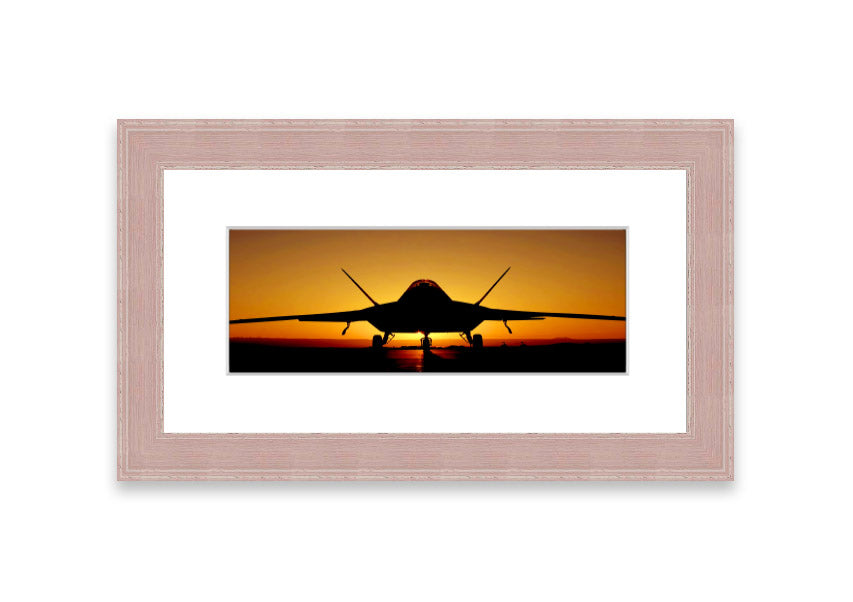 Framed print of an airplane at sunset, showcasing vibrant colors and a serene landscape.