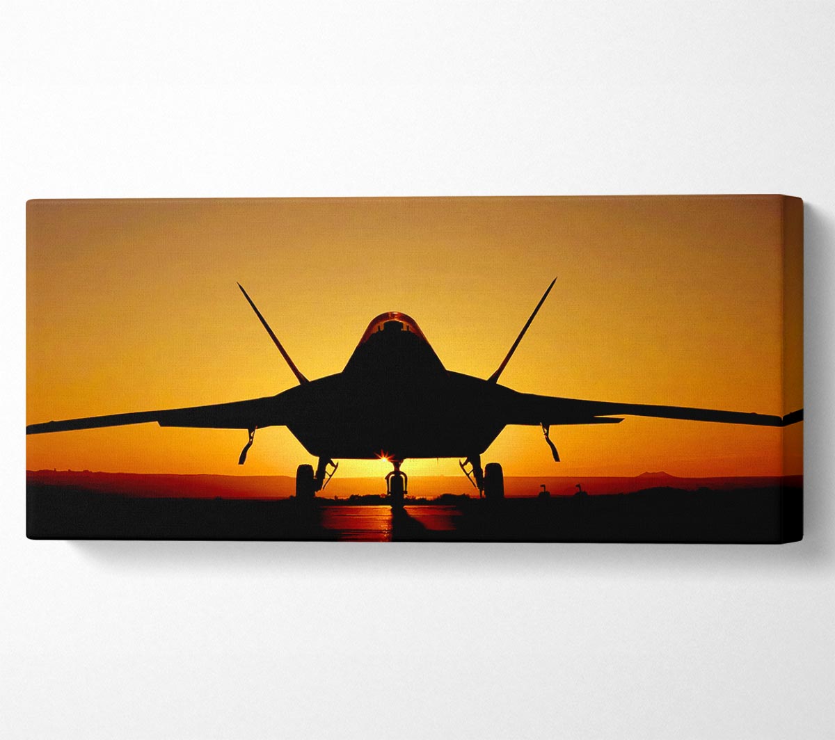 A beautiful canvas print of an airplane flying against a vibrant sunset sky, mounted on a sturdy box frame.